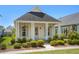 Charming single-story home featuring a covered porch with classic columns and manicured landscaping at 139 Clear Bend Ln, Summerville, SC 29486