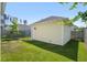 Backyard view of a detached garage with manicured lawn and blue sky at 139 Clear Bend Ln, Summerville, SC 29486