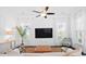 Sun-filled living room boasts stylish decor, hardwood floors, a ceiling fan, and abundant natural light at 139 Clear Bend Ln, Summerville, SC 29486
