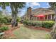 Lush backyard with large trees, a well-kept lawn, and a glimpse of a deck, creating a serene outdoor space at 1391 Southlake Dr, Mount Pleasant, SC 29464
