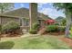 Well-maintained backyard featuring a brick house, green lawn, and a charming patio at 1391 Southlake Dr, Mount Pleasant, SC 29464