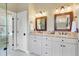 A full bathroom showcases double sinks, granite counters, and an array of lighting for a modern feel at 1391 Southlake Dr, Mount Pleasant, SC 29464