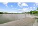 Scenic view of calm lake waters from a weathered wooden dock under a partly cloudy sky at 1391 Southlake Dr, Mount Pleasant, SC 29464