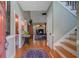 Home foyer with hardwood floors, a staircase, and views into the living room with fireplace and a half-bathroom at 1391 Southlake Dr, Mount Pleasant, SC 29464
