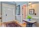 Bright and airy foyer with hardwood floors, elegant entryway mirror, and a view to the front door at 1391 Southlake Dr, Mount Pleasant, SC 29464