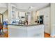 Kitchen view showcasing breakfast bar, white cabinets, stainless steel appliances, and open layout at 1391 Southlake Dr, Mount Pleasant, SC 29464