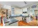 Well-lit kitchen featuring white cabinetry, modern appliances, and hardwood flooring at 1391 Southlake Dr, Mount Pleasant, SC 29464