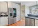 Open kitchen featuring stainless steel refrigerator, white cabinets, and hardwood floors at 1391 Southlake Dr, Mount Pleasant, SC 29464