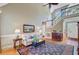 Bright living room with hardwood floors, a cozy sitting area, and staircase leading to the second floor at 1391 Southlake Dr, Mount Pleasant, SC 29464
