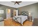 A spacious primary bedroom features hardwood floors, a ceiling fan, and an ensuite bathroom for convenience at 1391 Southlake Dr, Mount Pleasant, SC 29464