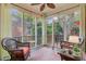 Cozy screened-in porch with comfortable wicker furniture and views of the backyard at 1391 Southlake Dr, Mount Pleasant, SC 29464