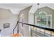 A bright landing features large windows overlooking the front yard and a modern light fixture above at 1391 Southlake Dr, Mount Pleasant, SC 29464