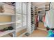 Custom walk-in closet with organized shelving and hanging space, complemented by natural light from the window at 1391 Southlake Dr, Mount Pleasant, SC 29464