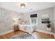 Stylishly decorated bedroom with unique wallpaper, hardwood floors, and bright natural light from the large window at 14 Paula Dr, Charleston, SC 29407