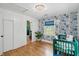 Bright Bedroom with blue floral wallpaper, hardwood floors, and a view into the adjacent bathroom at 14 Paula Dr, Charleston, SC 29407