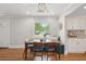 Bright dining room with hardwood floors, a dining table, and a large window overlooking greenery at 14 Paula Dr, Charleston, SC 29407