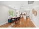 Open concept dining and kitchen area with hardwood floors and plenty of natural light at 14 Paula Dr, Charleston, SC 29407