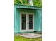Close up view of additional dwelling entrance with white double doors and a small porch at 14 Paula Dr, Charleston, SC 29407