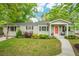 Charming single-story home with a landscaped front yard and a welcoming front porch at 14 Paula Dr, Charleston, SC 29407