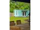 Backyard view of additional dwelling with a dining set under an umbrella in the yard at 14 Paula Dr, Charleston, SC 29407