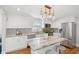 Bright kitchen featuring white cabinets, a large island, stainless appliances, and patterned tile backsplash at 14 Paula Dr, Charleston, SC 29407