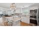 Bright kitchen featuring white cabinets, a large island, stainless appliances, and patterned tile backsplash at 14 Paula Dr, Charleston, SC 29407
