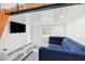 Bright living room with white walls, a comfortable blue sofa, and a modern entertainment center with mounted TV at 14 Paula Dr, Charleston, SC 29407