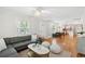 Open-concept living room featuring hardwood floors, a gray sectional couch, and seamless access to the dining area at 14 Paula Dr, Charleston, SC 29407