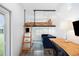 Cozy living space featuring a lofted bed, blue sofa, and wood desk at 14 Paula Dr, Charleston, SC 29407