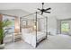 Serene bedroom with a canopy bed, neutral decor, and soft lighting, creating a relaxing retreat at 14 Paula Dr, Charleston, SC 29407