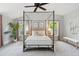 Serene bedroom with a canopy bed, neutral decor, and soft lighting, creating a relaxing retreat at 14 Paula Dr, Charleston, SC 29407