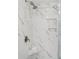 Modern walk-in shower with marble-like tile, built in shampoo shelves and updated shower head at 14 Paula Dr, Charleston, SC 29407