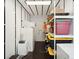 Well-organized storage area with shelving, storage containers, and an air conditioner for climate control at 14 Paula Dr, Charleston, SC 29407