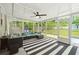 Relaxing sunroom featuring a comfortable seating area, striped rug, and plenty of natural light at 14 Paula Dr, Charleston, SC 29407