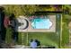 Aerial view of a backyard featuring a pool, seating area, lush landscaping, and a well-maintained lawn at 1427 Wando View St, Charleston, SC 29492