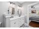 Modern bathroom featuring double vanity, mirrors, and shower with herringbone tile at 1427 Wando View St, Charleston, SC 29492