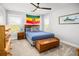 Bright bedroom with a bed, ceiling fan, and two windows providing natural light at 1427 Wando View St, Charleston, SC 29492