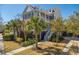 Exterior elevation showcasing a two-story home and manicured lawn with trees at 1427 Wando View St, Charleston, SC 29492