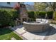 Outdoor brick fireplace with curved seating area and lush greenery, creating a tranquil and inviting space at 1427 Wando View St, Charleston, SC 29492