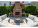Charming outdoor brick fireplace and curved couch creating an inviting and cozy outdoor living space at 1427 Wando View St, Charleston, SC 29492