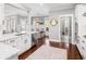 Bright, open kitchen with white cabinets, stainless steel appliances, and hardwood floors at 1427 Wando View St, Charleston, SC 29492