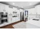 Modern kitchen with stainless steel appliances, white cabinets, and hardwood floors at 1427 Wando View St, Charleston, SC 29492