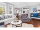 Bright living room showcasing a white sofa, stylish armchairs, and an open layout to the dining area and kitchen at 1427 Wando View St, Charleston, SC 29492