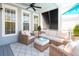 Relaxing outdoor patio with wicker furniture, a ceiling fan, and privacy screens for comfortable outdoor living at 1427 Wando View St, Charleston, SC 29492
