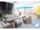 Comfortable outdoor patio furnished with wicker seating, an umbrella, a ceiling fan, and a pergola at 1427 Wando View St, Charleston, SC 29492