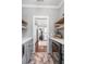 Walk-in pantry featuring open shelving, tile floors, and gray cabinets at 1427 Wando View St, Charleston, SC 29492