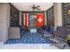 Inviting outdoor patio with comfortable seating, a ceiling fan, and decorative flags for a relaxing ambiance at 1427 Wando View St, Charleston, SC 29492