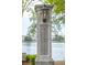 Close up of the Smythe Park entry pillar with a lantern with a view of the lake in the background at 1427 Wando View St, Charleston, SC 29492