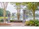 A scenic park view featuring a tranquil lake, park bench, and lantern-lit entry columns at 1427 Wando View St, Charleston, SC 29492
