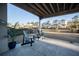 Inviting covered patio with Adirondack chairs overlooks a fenced backyard and scenic community pond at 1464 Stratton Pl, Mount Pleasant, SC 29466